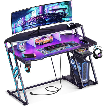 MOTPK Gaming Desk with Power Outlet & LED Lights, Computer Desk 47inch with PC Storage Shelf, Gaming Table with Carbon Fiber Texture, Gamer Desk, Gift for Boys Men, Black