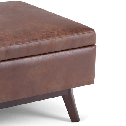 SIMPLIHOME Owen Coffee Table Storage Ottoman - 34" Wide x 19" High Upholstered Vegan Leather Rectangular Lift-Top Ottoman in Distressed Saddle Brown, Mid-Century Modern Bench with Tapered Legs