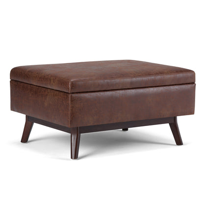 SIMPLIHOME Owen Coffee Table Storage Ottoman - 34" Wide x 19" High Upholstered Vegan Leather Rectangular Lift-Top Ottoman in Distressed Saddle Brown, Mid-Century Modern Bench with Tapered Legs