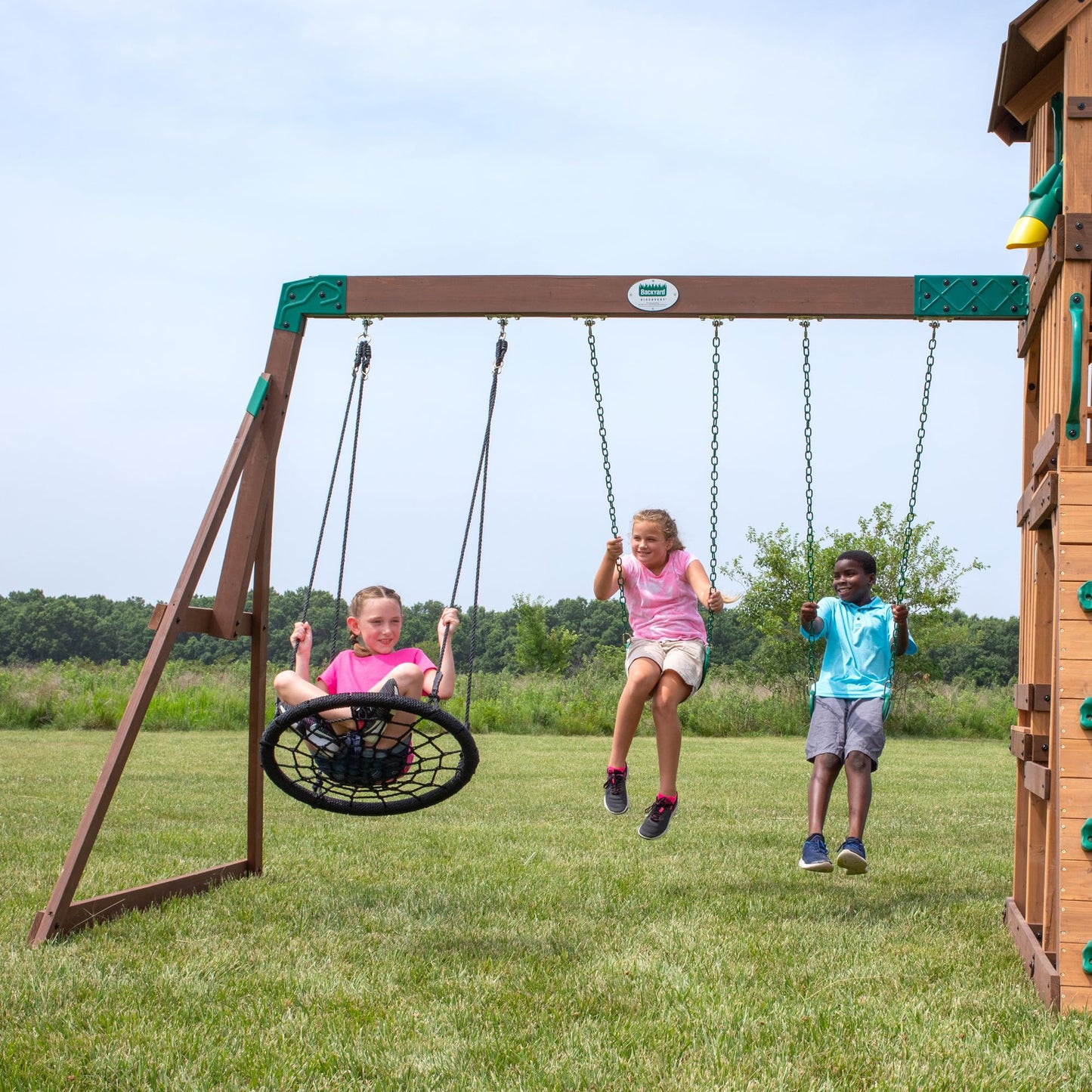 Backyard Discovery Highlander Cedar Wood Swing Set with Wave Slide, Three-Story Clubhouse, Rock Wall, Picnic Table, Belt Swings, Web Swing, Sandbox, Three Ladders, Toy Accessories, Outdoor Playset